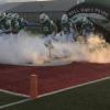 The Wall Hawks charge out of the tunnel before a game against Shiner in 2021.