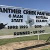 A sign at Panther Creek High School displays the football program's accomplishments.