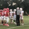 The captains for Miles and Albany meet for the coin toss Friday, Oct. 11, 2024, in Albany.