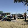 First responders assess the scene after two Dodge Ram pickups collided near the intersection of North Taylor Street and Sherwood Way. One of the trucks sustained heavy front-end damage, while no serious injuries were reported.