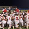 The Miles Bulldogs football team prays before its first-round playoff game against Lindsay in Brock on Thursday, Nov. 14, 2024.