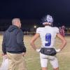 Richland Springs head coach Shawn Rogers talk to his son, quarterback Hutton Rogers, during the Coyotes' 64-6 second-round playoff win over Zephyr on Friday, Nov. 22, 2024.