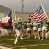 The Wall Hawks football team charges onto the field before its first-round playoff game with Anthony on Friday, Nov. 15, 2024.