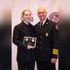 Megan Smith, honored as Odessa Firefighter of the Year, stands proudly with an OFR official after receiving her award for exemplary service and dedication.