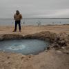 Hawk Dunlap stands at the site of Lake Boehmer, a brine lake that has leaked out of an old well in Pecos County. The Texas Commission on Environmental Quality received $10 million from lawmakers in 2023 to plug such wells but has yet to spend any of the money as it completes the rule making process.