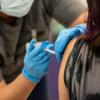 A nurse administers a dose of the Pfizer COVID vaccine at a clinic organized by the Travis County Mobile Vaccine Collaborative at Rodriguez Elementary School on July 28, 2021.