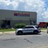 At least two people were taken to the hospital Wednesday afternoon after a car crashed through the Firestone Complete Auto Care building on Knickerbocker Road.