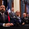From left, House Speaker Dustin Burrows, Gov. Greg Abbott and Lt. Gov. Dan Patrick hold a bill signing ceremony at the Texas Capitol on April 23, 2025 to create a Texas Department of Government Efficiency.