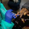 Bessie Bell, 96, receives her first dose of the COVID-19 vaccine at Fair Park, Dallas County's public vaccination site, on Jan. 11, 2021.