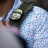 A U.S. Immigration and Customs Enforcement agent’s badge in front of the J.J. Pickle Federal Building in Austin on April 1, 2025. 
