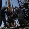 A service rig crew pulls sucker rods from an oil and gas well as they work to bring a downhole pumping unit to the surface on Aug. 14, 2024, in West Odessa.