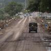 Emergency vehicles cross the debris-covered San Antonio Street bridge in Center Point, on July 16, 2026, after floodwaters from the Guadalupe River overtook it that morning.