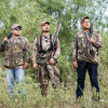 Three people are shown dove hunting.
