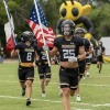 The Menard football team runs onto the field during the 2026 season.