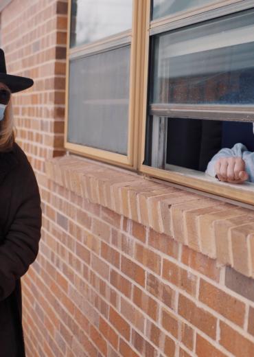 Brenda Gunter speaks to a resident on Dellwood Drive in southeast San Angelo. 