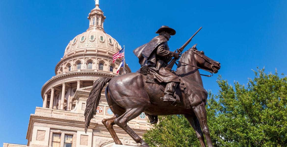 The Texas Capitol behind the Terry's Texas Rangers Monument