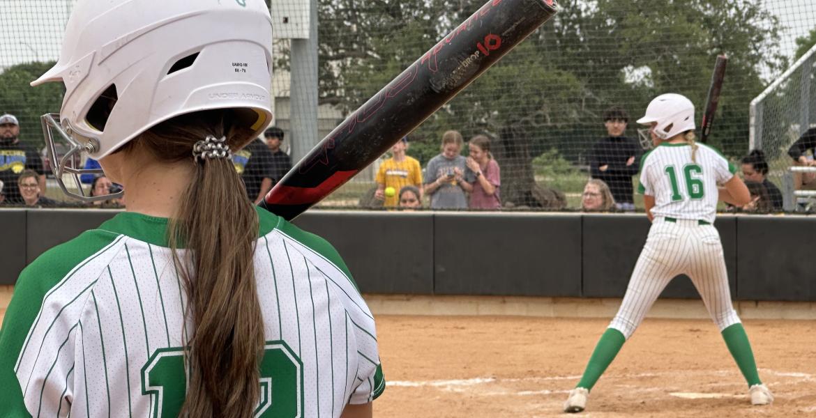 Wall Lady Hawks Abby Werner looks on from the on-deck circle while Emery Harper is at bat.