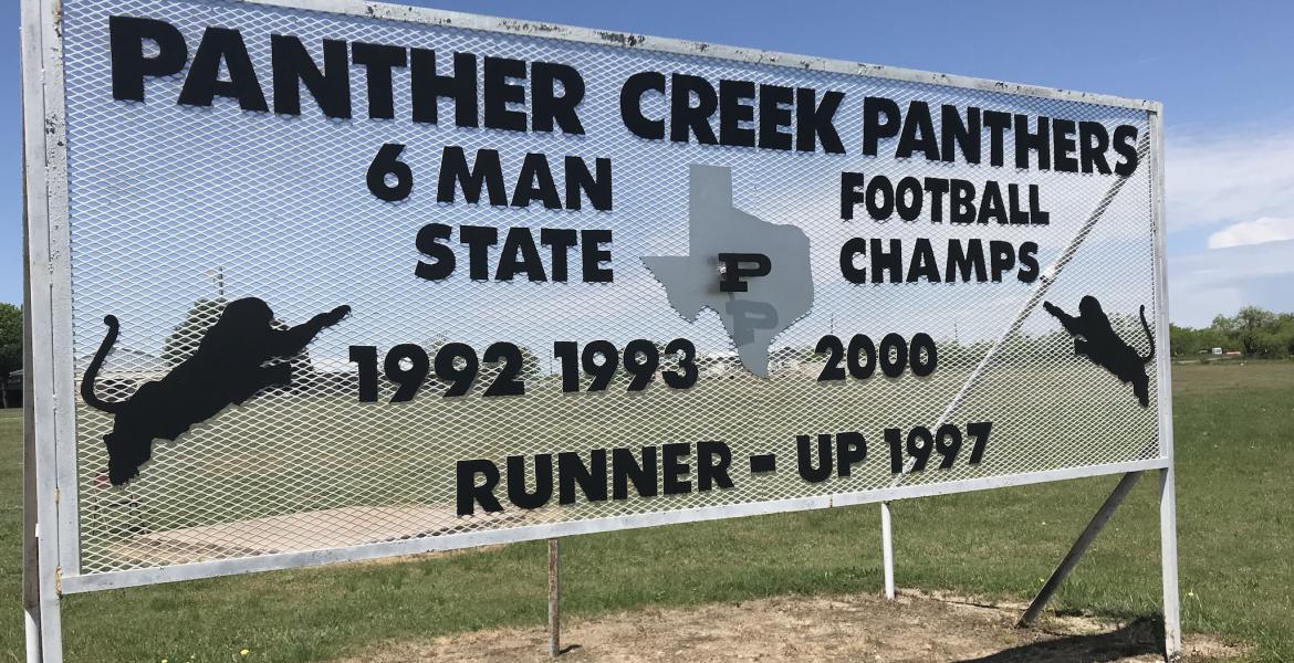 A sign at Panther Creek High School displays the football program's accomplishments.