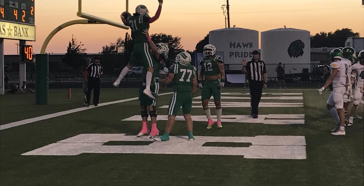 Wall's Ethan Michalewicz is picked up by Ben Taylor after a touchdown against Idalou on Friday, Oct. 4, 2024.