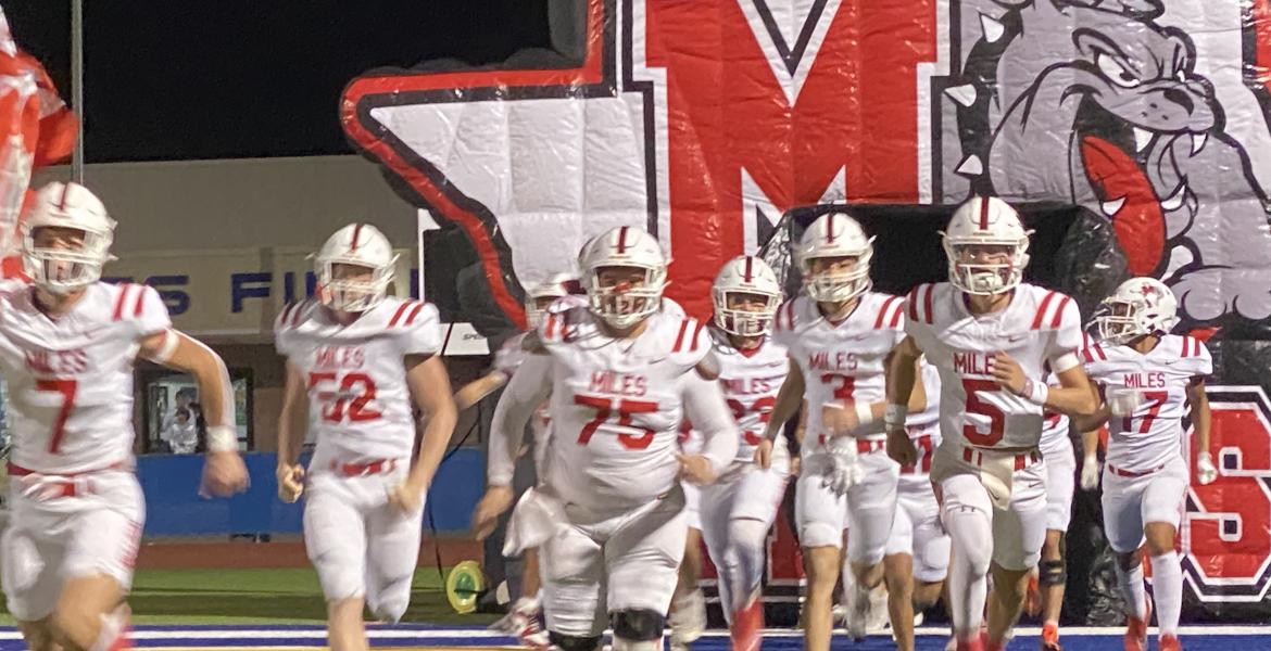 The Miles Bulldogs charge onto the field before their first-round playoff game against Lindsay on Thursday, Nov. 14, 2024.