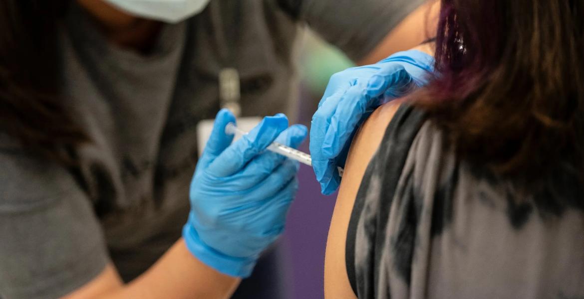 A nurse administers a dose of the Pfizer COVID vaccine at a clinic organized by the Travis County Mobile Vaccine Collaborative at Rodriguez Elementary School on July 28, 2021.