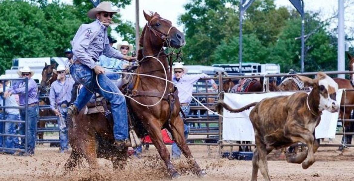 Caleb Smidt is showing roping a calf at an event in Bellville in 2014.