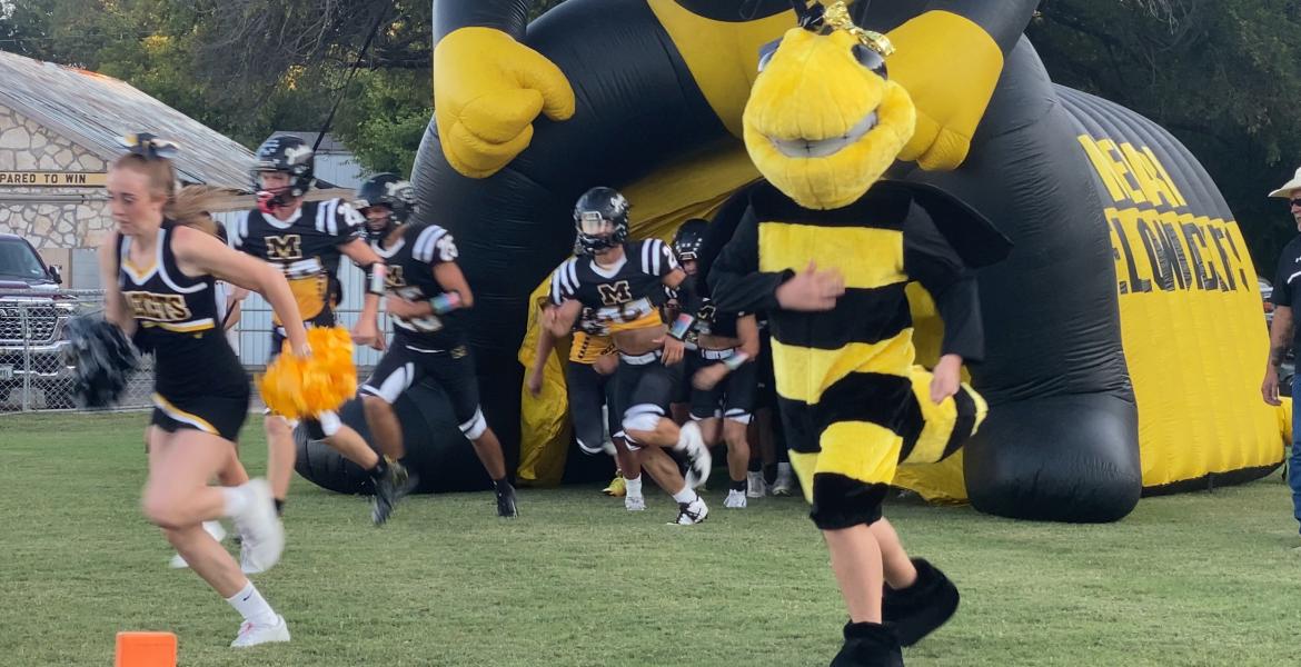 The Menard Yellow Jackets run onto the field before a game against Rocksprings during the 2025 season.