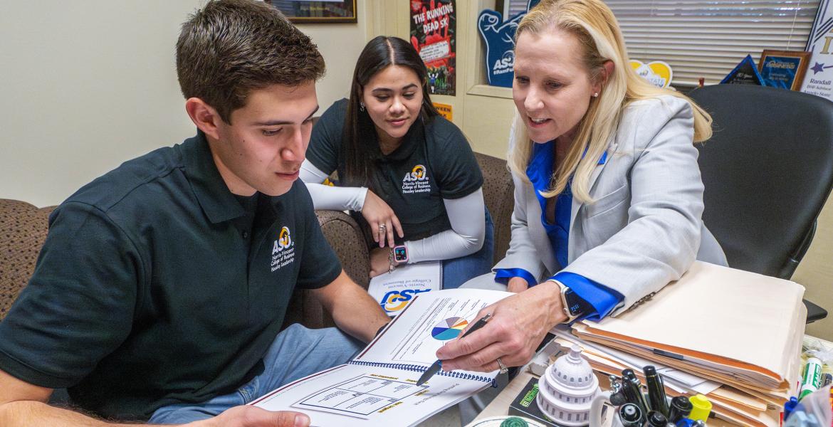 ASU business professor, Dr. Gayle Randall, working with students in her office