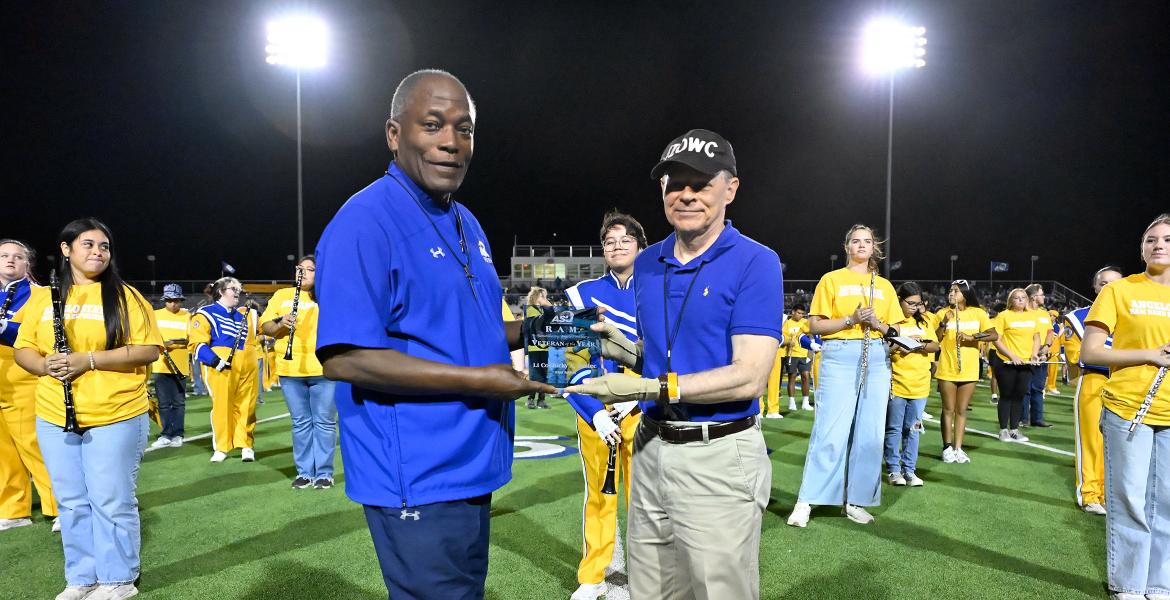 (L-R) ASU President Ronnie Hawkins presented Ricky Hudec the 2025 ASU Veteran of the Year plaque during ASU's Military Appreciation Day football game Nov. 8