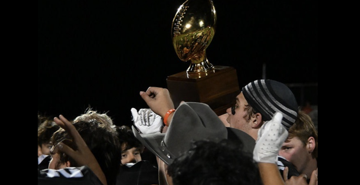 The Water Valley Wildcats hoist a bidistrict playoff trophy after their 62-14 win over Hermleigh on Thursday, Nov. 13, 2025.