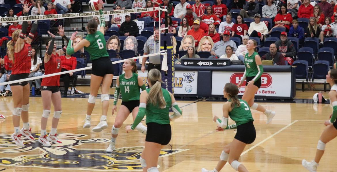 Wall's Peyton Dickson (6) rises up for a kill while Kynlee Stevens (14) looks on during the Lady Hawks' win over Holliday in the regional final.