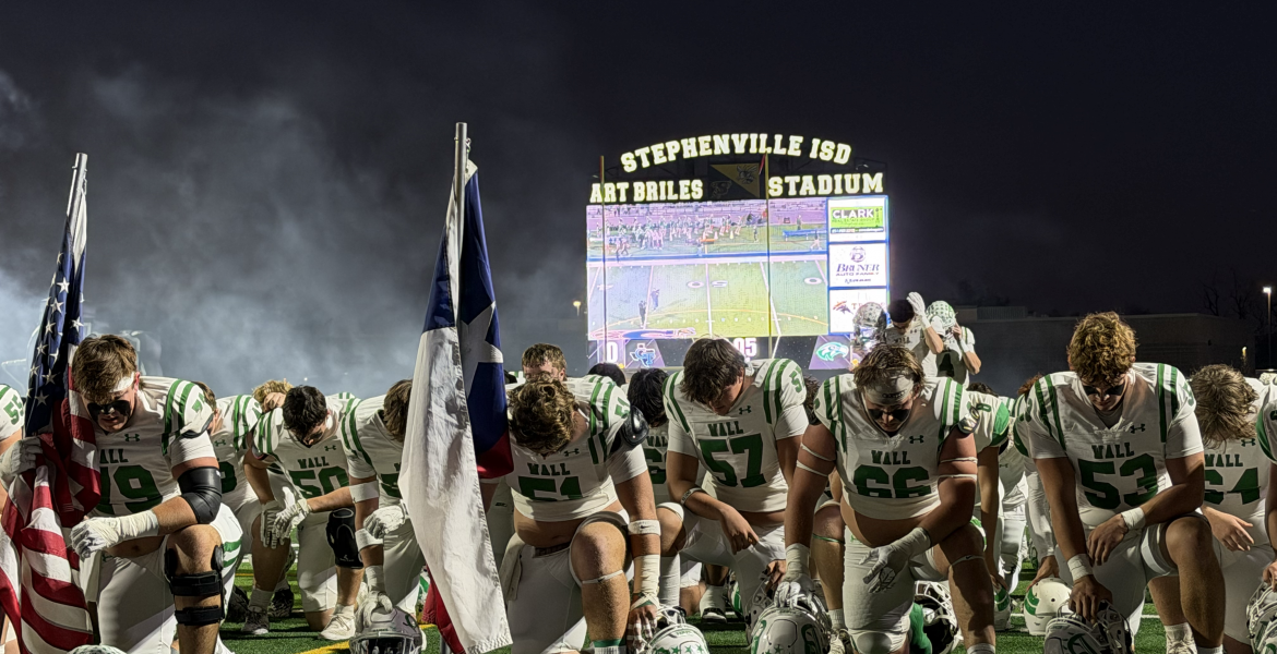The Wall Hawks take a moment to pray before their state semifinal game against Gunter on Friday, Dec. 12, 2025, in Stephenville.