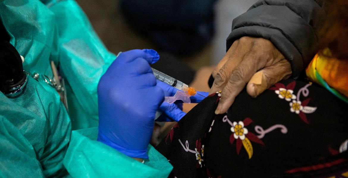 Bessie Bell, 96, receives her first dose of the COVID-19 vaccine at Fair Park, Dallas County's public vaccination site, on Jan. 11, 2021.