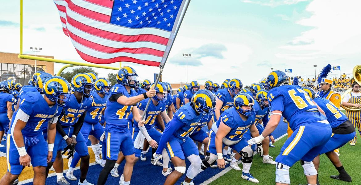 The Angelo State football team prepares to run onto the field before a game during the 2025 season.