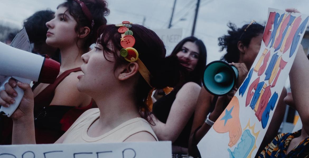 Protesters, many of them high school students, show up in front of a site believed to be an ICE detention facility on Algreg Street in Pflugerville on Feb. 13, 2026.