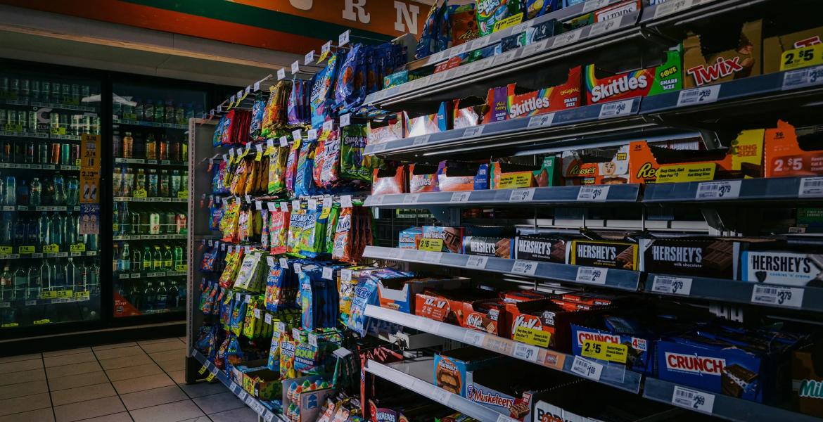 Candy bars and other sweets are displayed in the candy aisle of a convenience store in Austin on March 11, 2026. Beginning April 1, people will not be allowed to purchase candy and certain sweetened beverages using SNAP benefits.