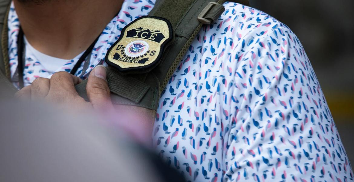 A U.S. Immigration and Customs Enforcement agent’s badge in front of the J.J. Pickle Federal Building in Austin on April 1, 2025.