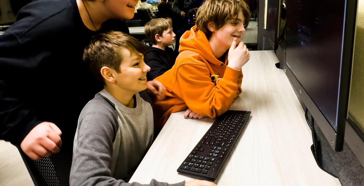 Arthur Grenner, 13, left, Chad Darden, 12, and Steve Yanes, 13, at right, engage with the video game platform Roblox during the Thousand Oaks Teen Center's reopening celebration in Thousand Oaks, California on March 10, 2023.