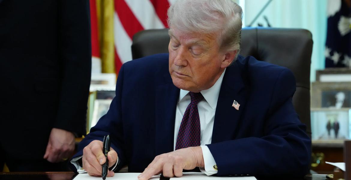 President Donald Trump signs an executive order on election integrity in the Oval Office of the White House in Washington on March 31, 2026.