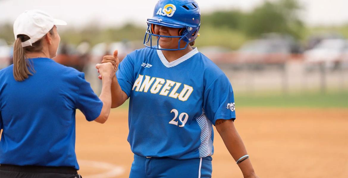 Angelo State's Zoey Sifuentes fist bumps Rambelles assistant coach Katie Scott during their doubleheader against UT Permian Basin in Odessa on Wednesday, April 1, 2026.