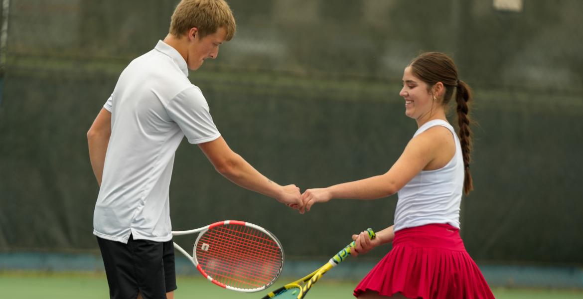 Garden City's Presley Jost and Lacy Seidenberger celebrate a point during the 2026 UIL Tennis State Championships. They went on to win the Class 1A mixed doubles state title.