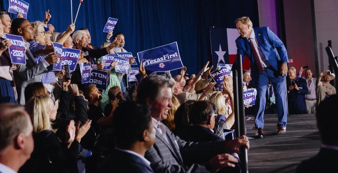 Texas Attorney General Ken Paxton shakes hands with cheering supporters at his election night watch party in Plano after winning the Republican candidacy for U.S. Senate on May 26, 2026.