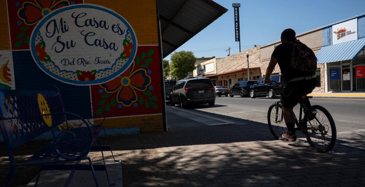 A cyclist rides their bike through downtown Del Rio on Aug. 21, 2024.