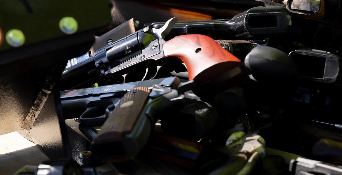 San Antonio police officers collect firearms and ammunition during a gun buyback event at the Alamodome on Nov. 24, 2024.