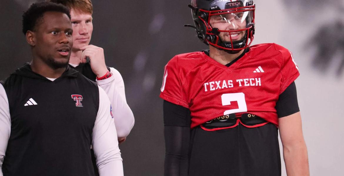 Texas Tech players Brendan Sorbsy (right) and Willi Hammond (back) and assistant quarterbacks coach Lindsey Scott look on during spring football practice at the at the Womble Football Center in Lubbock on April 7, 2026.