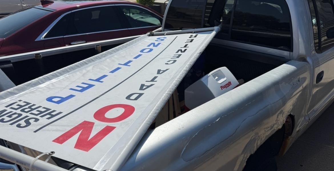 A sign advertising the recall petition of Mayor Tom Thompson in the back of Richard Summers' rusty, old Dodge pickup. He drove to city hall to deliver only 2/3s the petitions required to recall Mayor Tom Thompson.