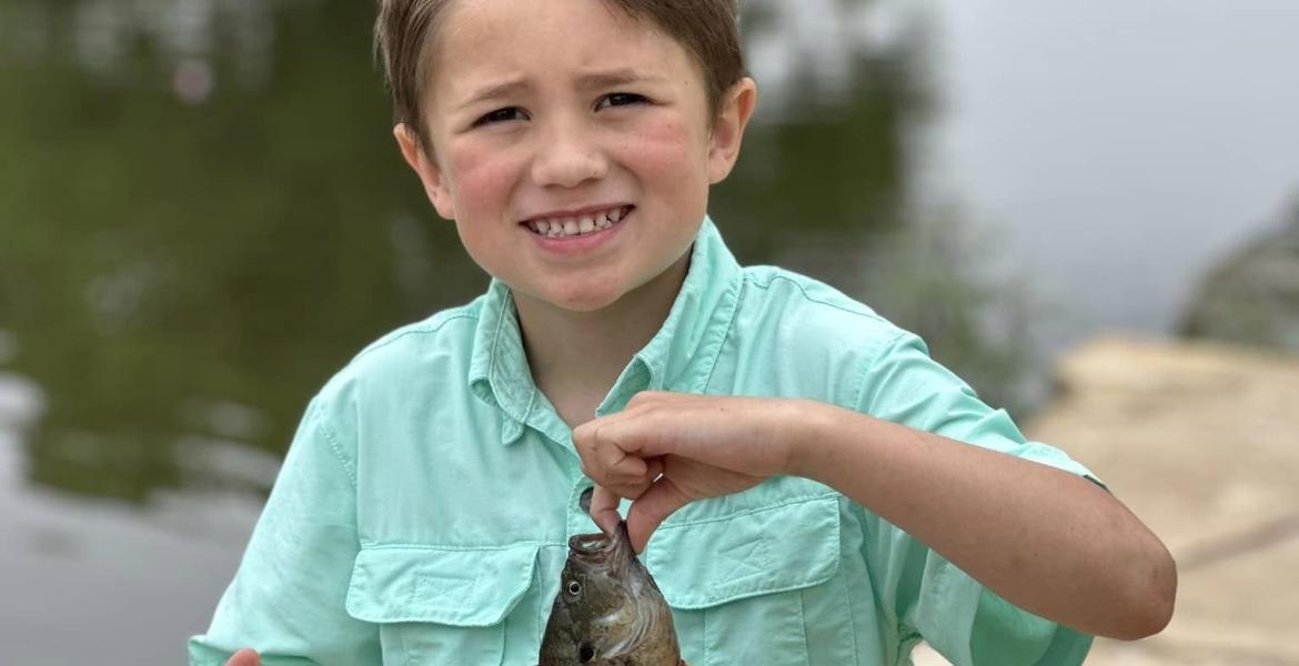 Kid caught a fish at fishing derby