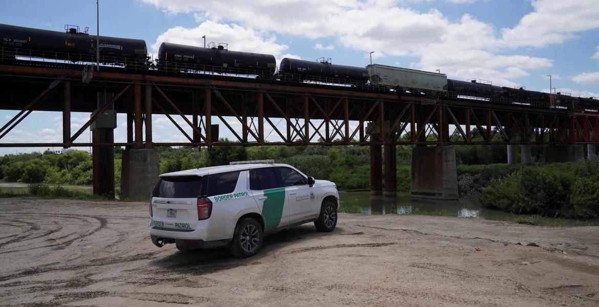 Border Patrol agents monitor the Rio Grande on May 11, 2026, after six bodies were found in a train boxcar in Laredo.