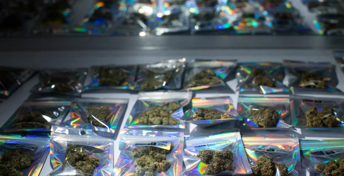 Individual packages of THC-A flower are seen in a display case at a smoke shop in Austin on May 13, 2026.
