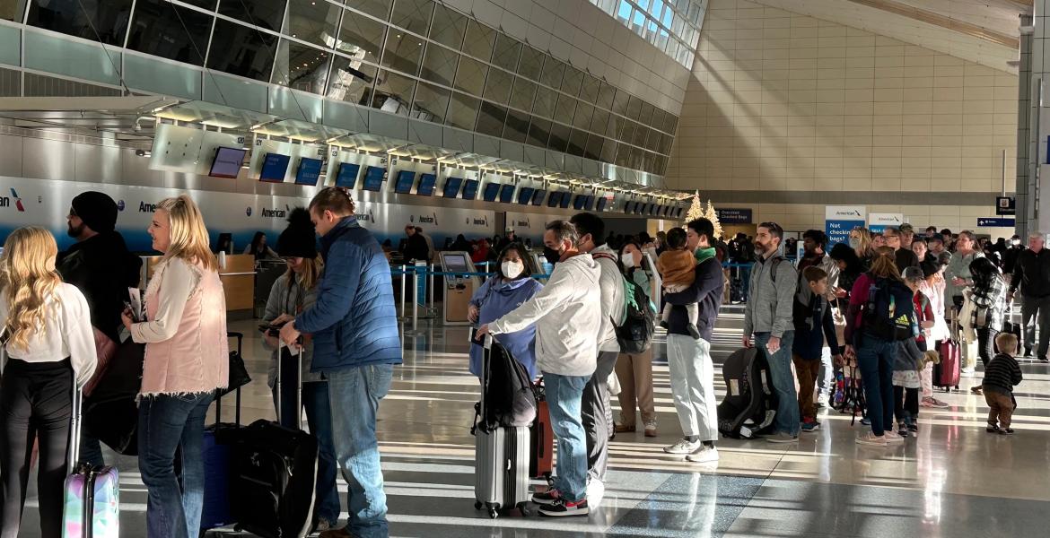 American Airlines passengers wait in a TSA security line at Dallas Fort Worth International Airport, Dec. 18, 2022.